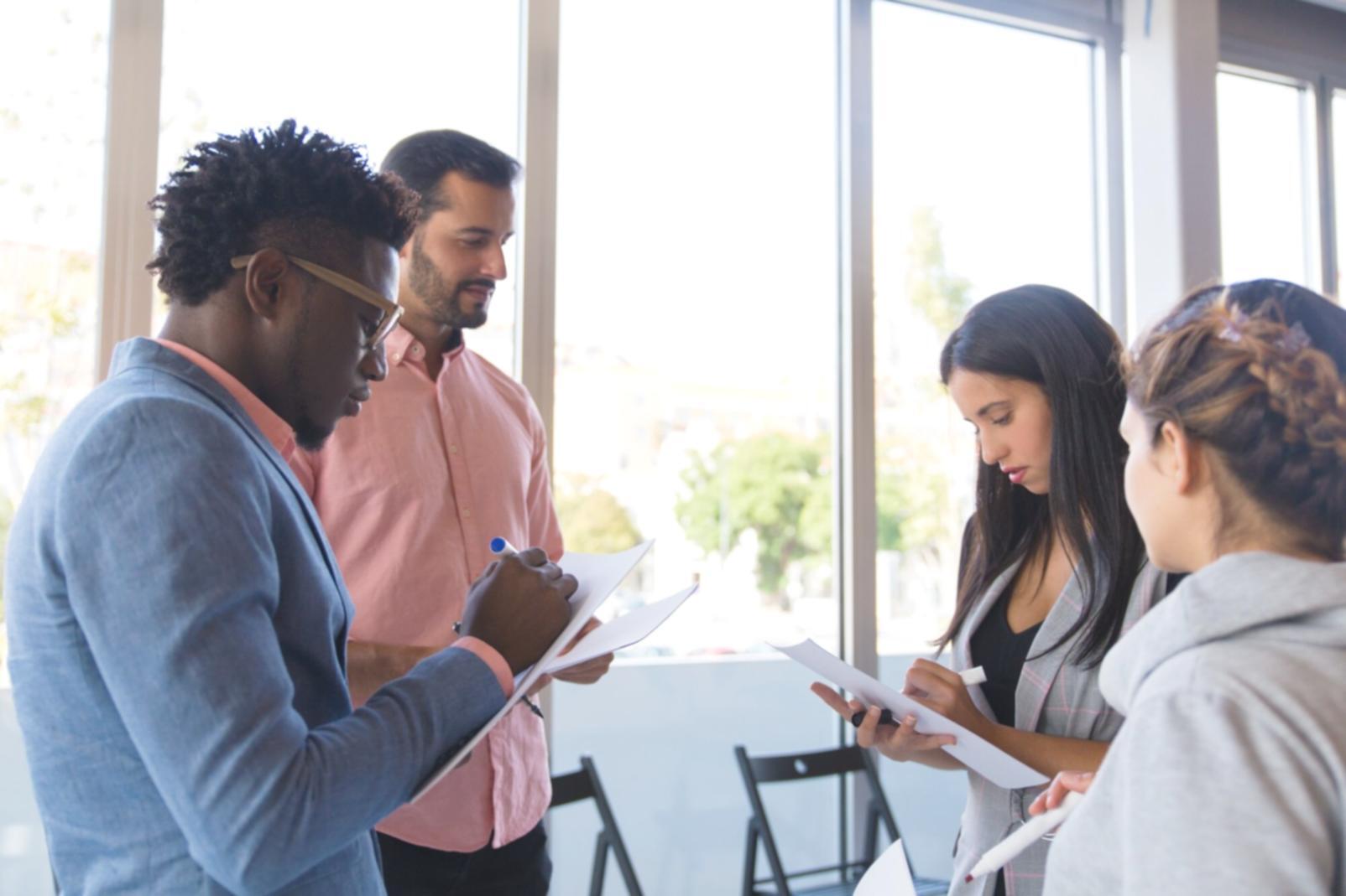 Advanced financial modeling workshop with analysts collaborating on valuation techniques